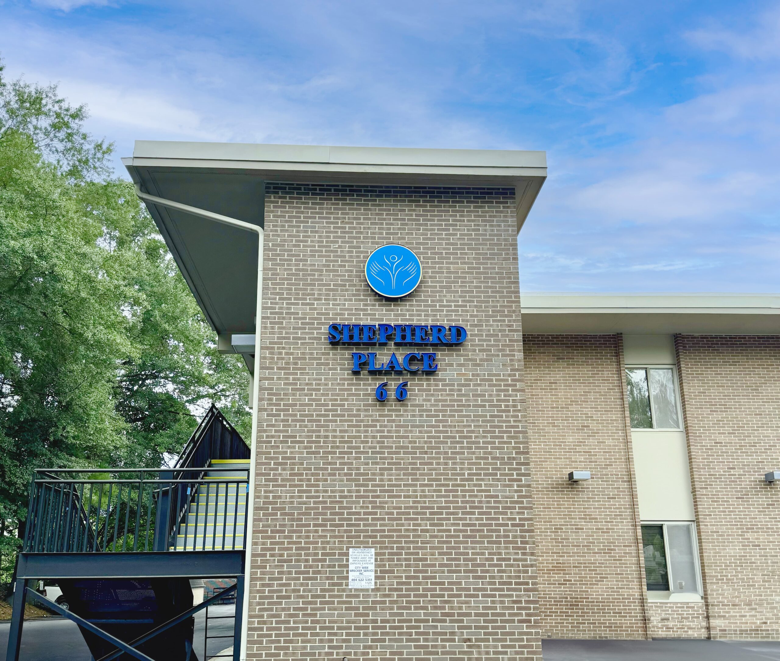A brick building with the sign 