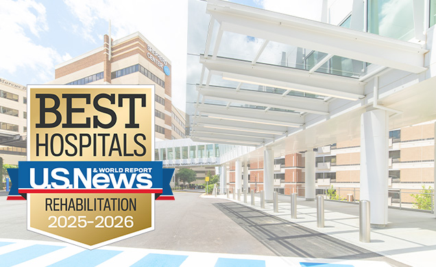 A hospital entrance displays a large sign reading 